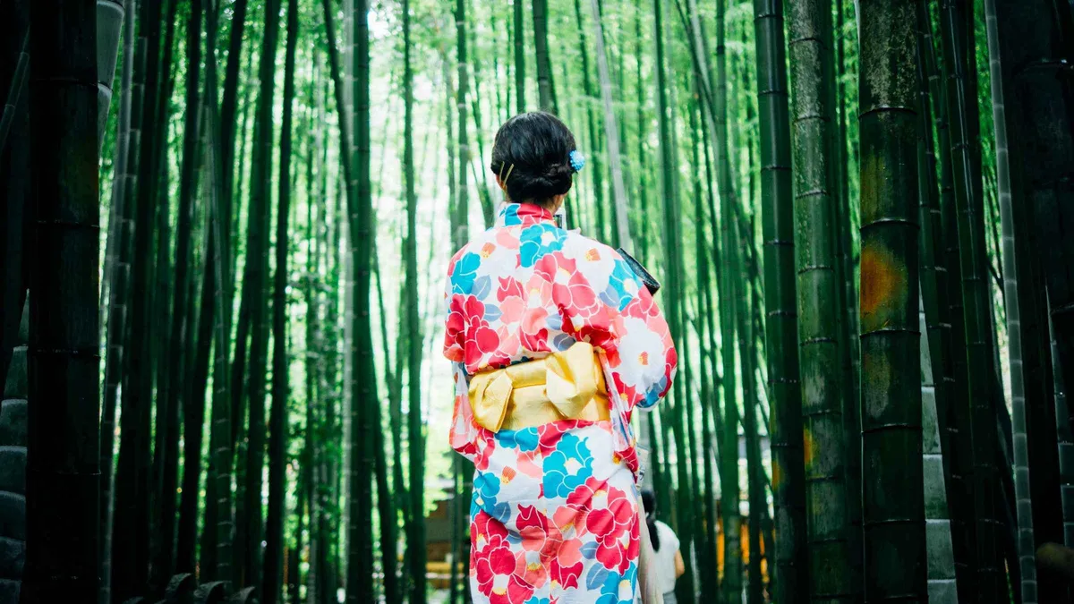 Empty gravel path through the Arashiyama Bamboo Forest at dawn on an early access tour in Kyoto, Japan